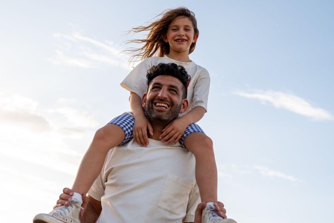 Dad and daughter on his shoulder.