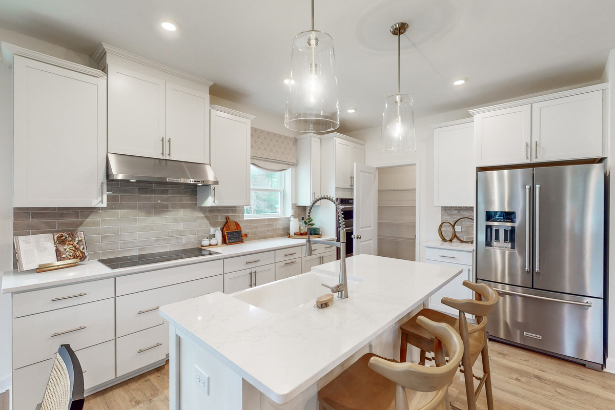 kitchen with white cabinets and tile backsplash 