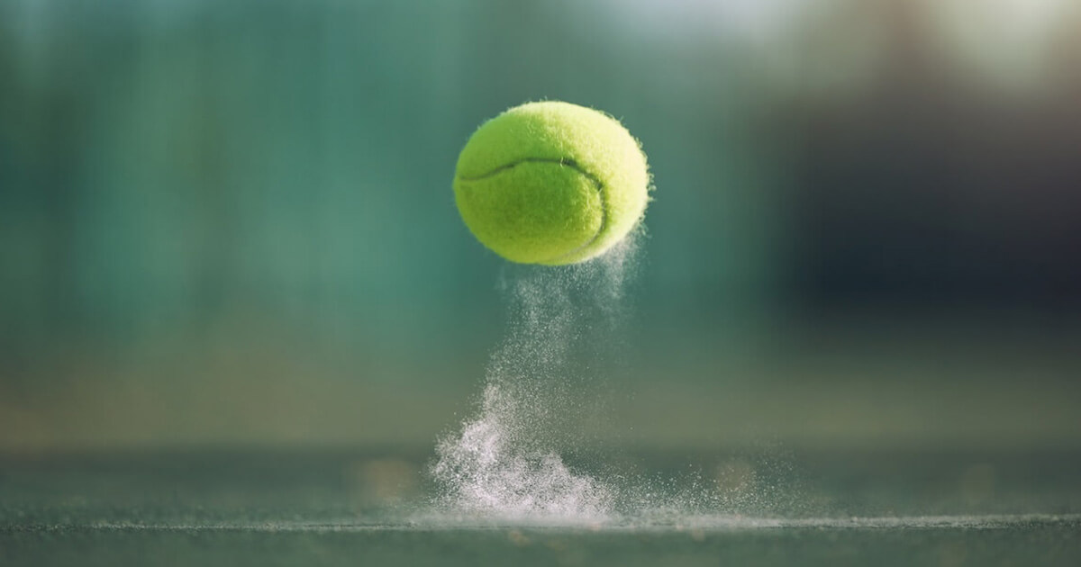 Image of a tennis ball in mid-air.