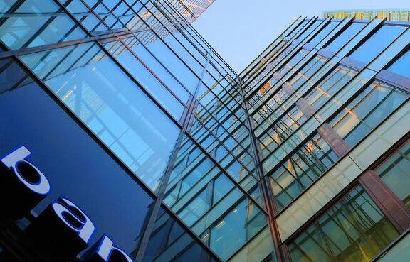 Upward view of a glass fronted bank building