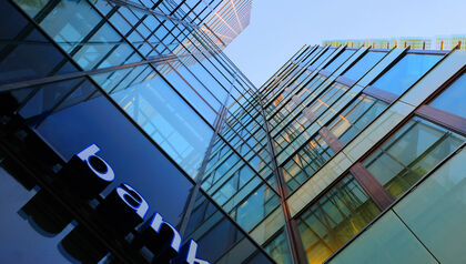 Upward view of a glass fronted bank building