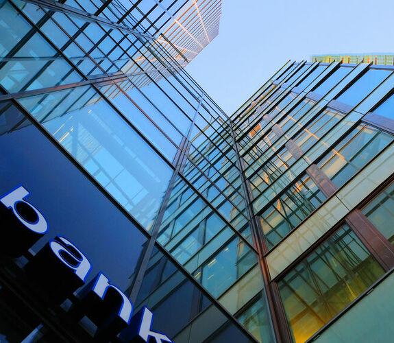 Upward view of a glass fronted bank building
