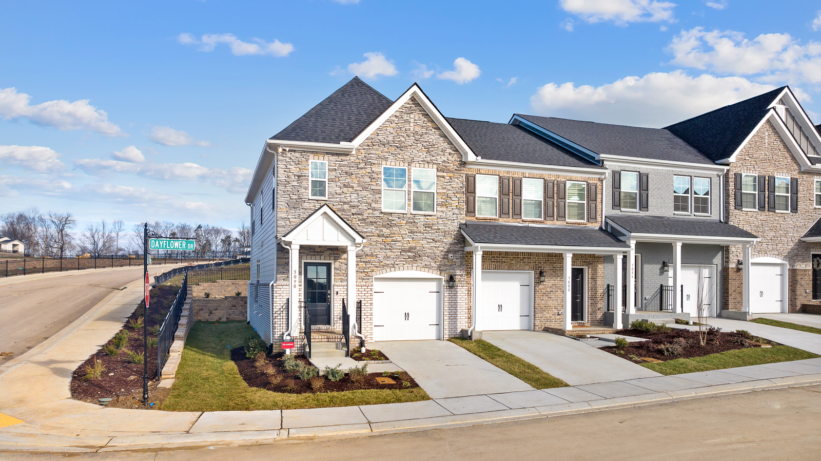 exterior of 3 brick townhome units