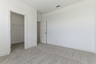 secondary bedroom with carpet, large windows, and walk-in closet