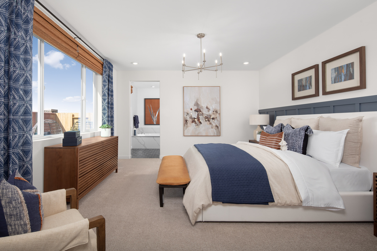 bedroom with white bed and brown dresser