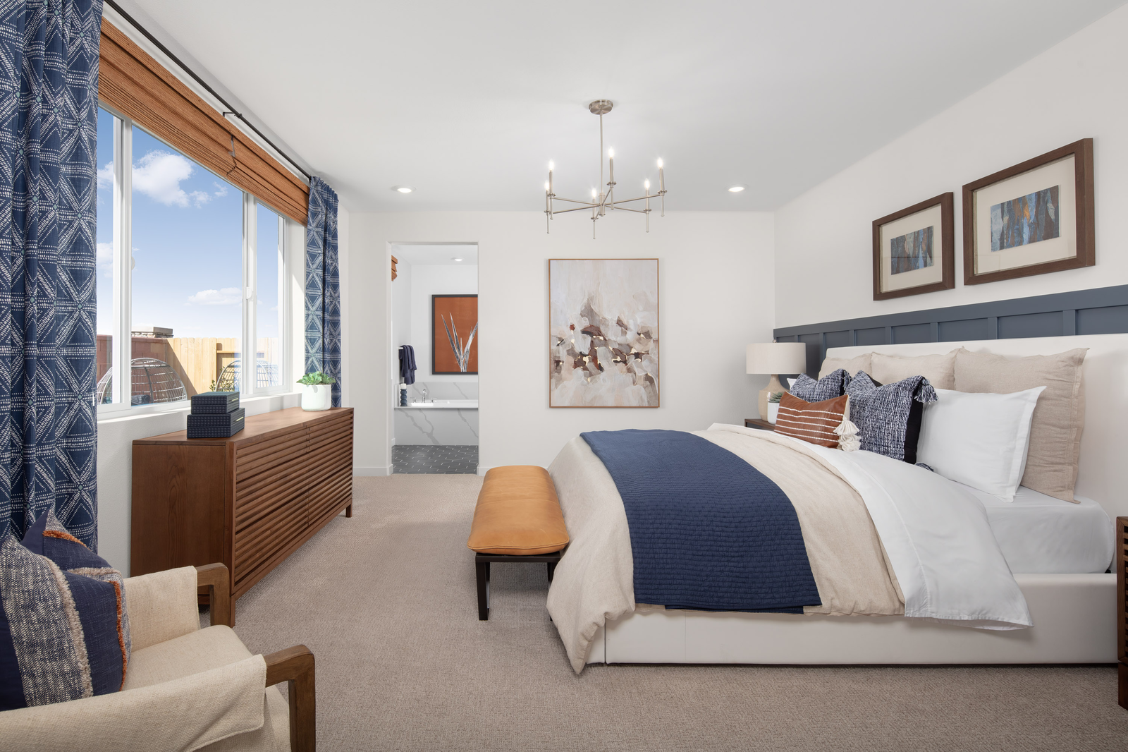 bedroom with white bed and brown dresser