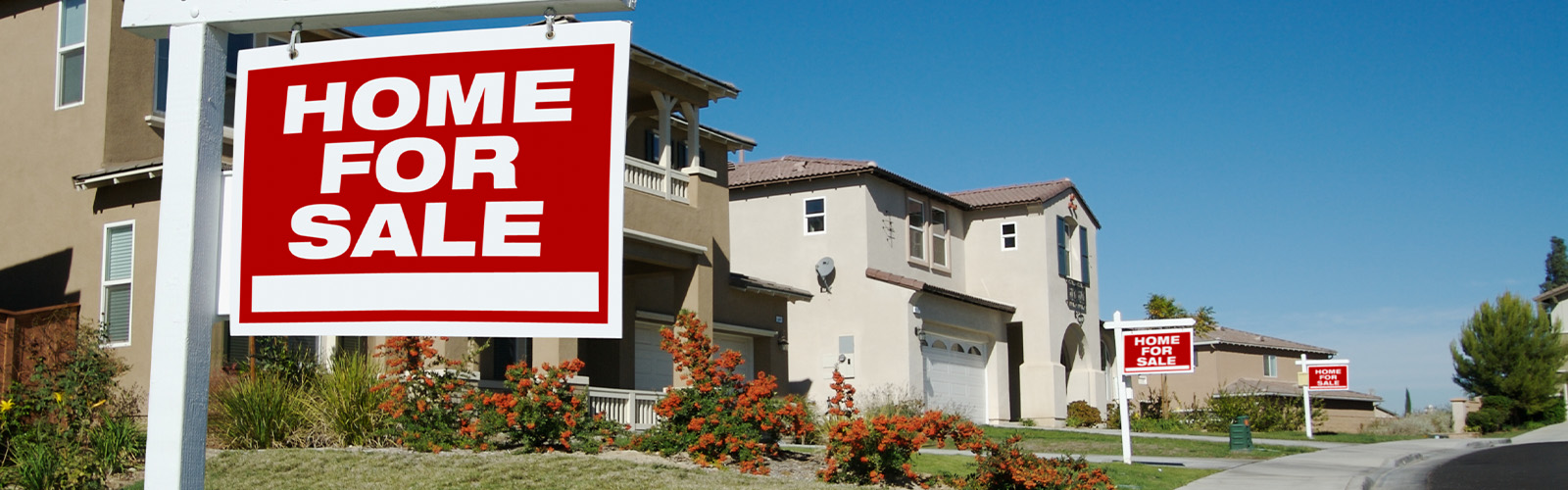 A for sale in front of a home