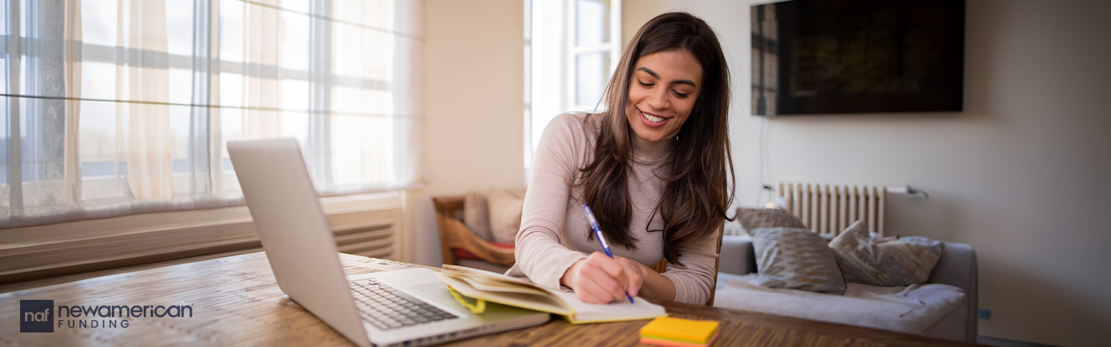 A woman smiling as she does paperwork.