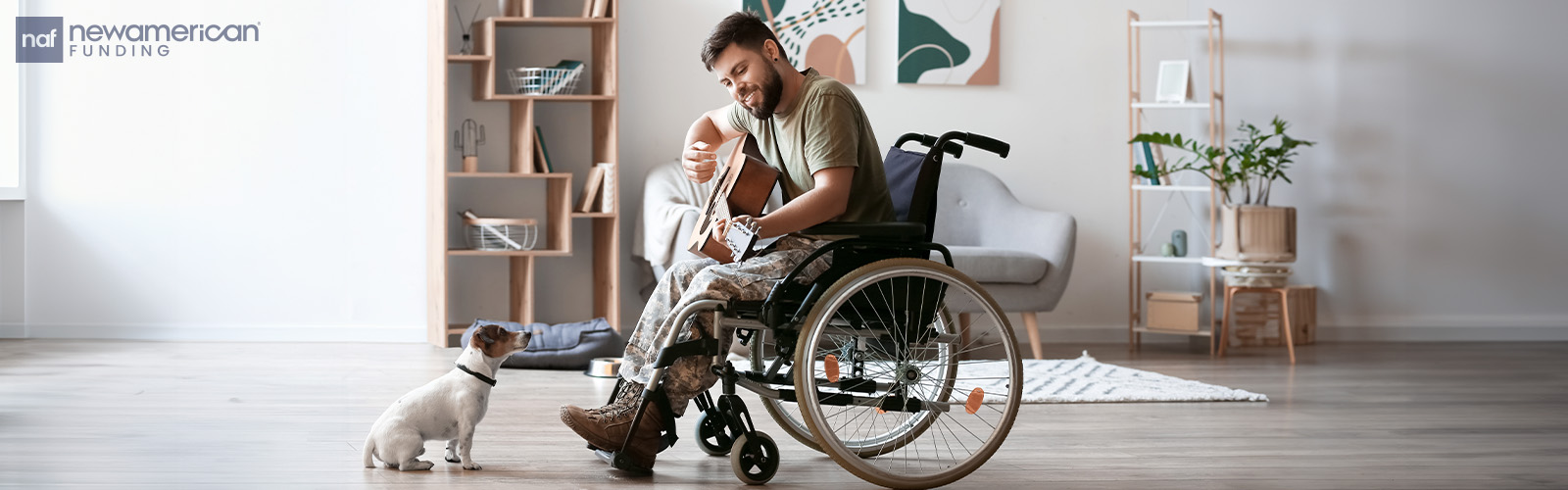 A military man sits in a wheelchair playing guitar while a small dog sits in front of him listening