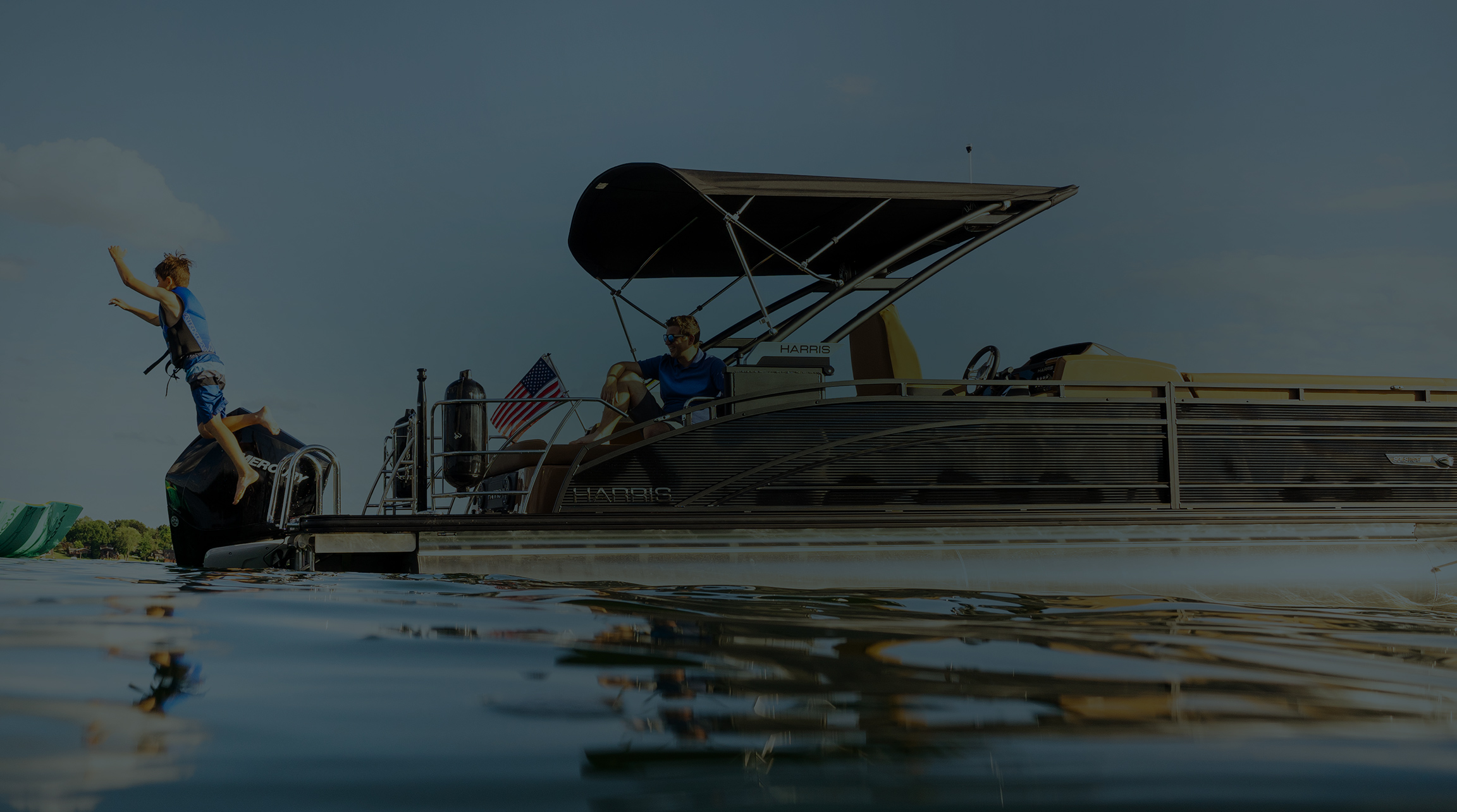 A child jumping off of a pontoon boat