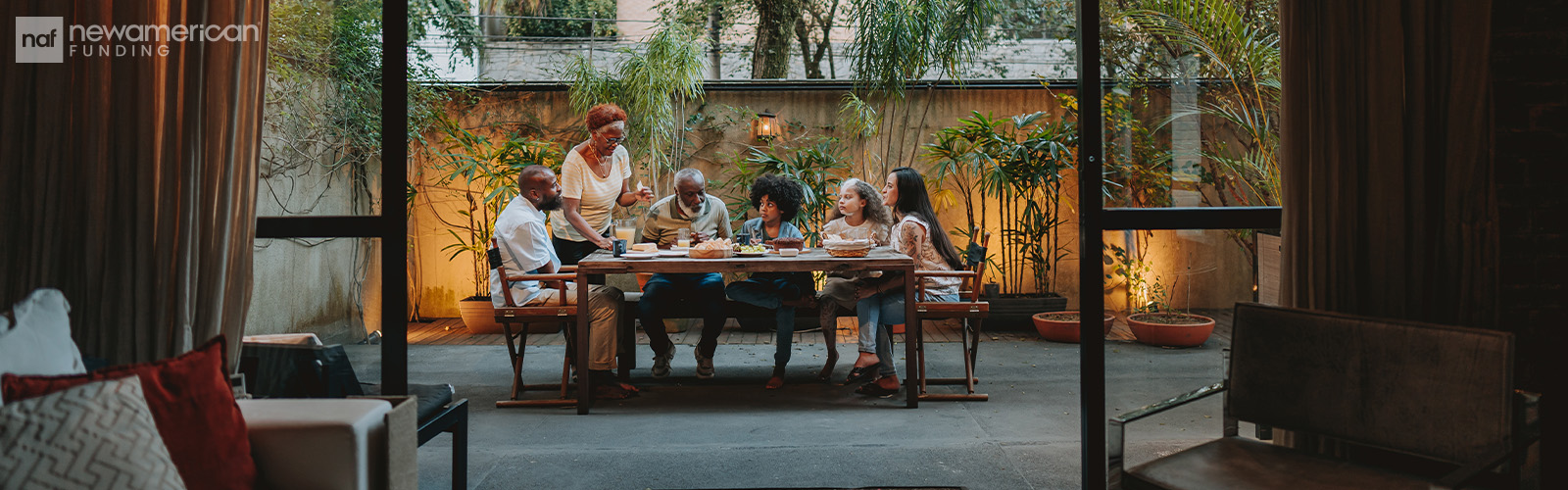 An extended family eating on an outdoor patio.