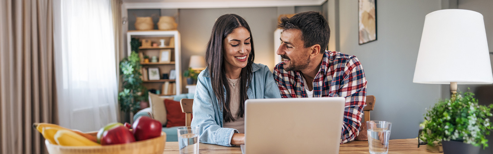 Couple at laptop reviewing finances