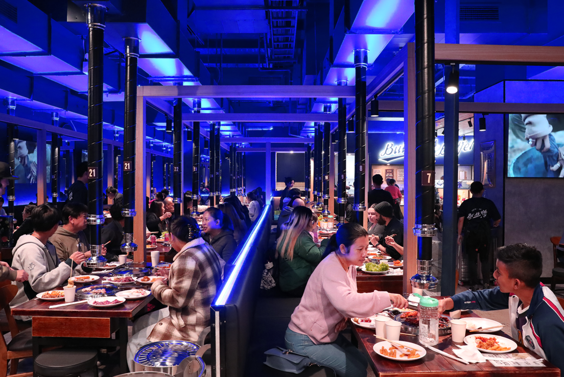 Customers enjoying Korean BBQ inside Butchers Buffet
