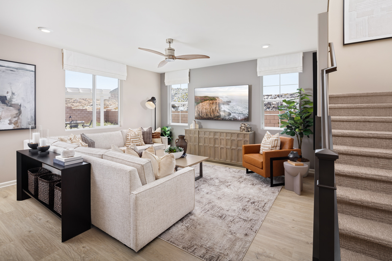 great room with large windows and neutral floors