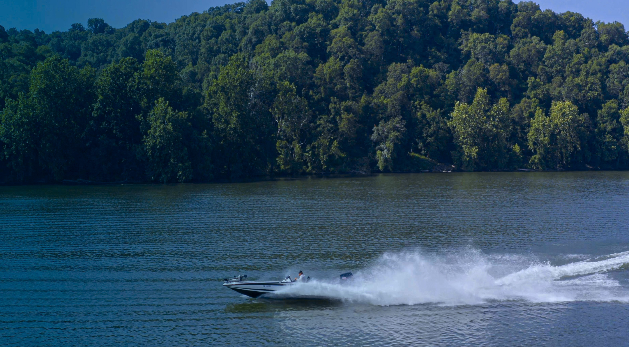 A speedboat sailing across a lake