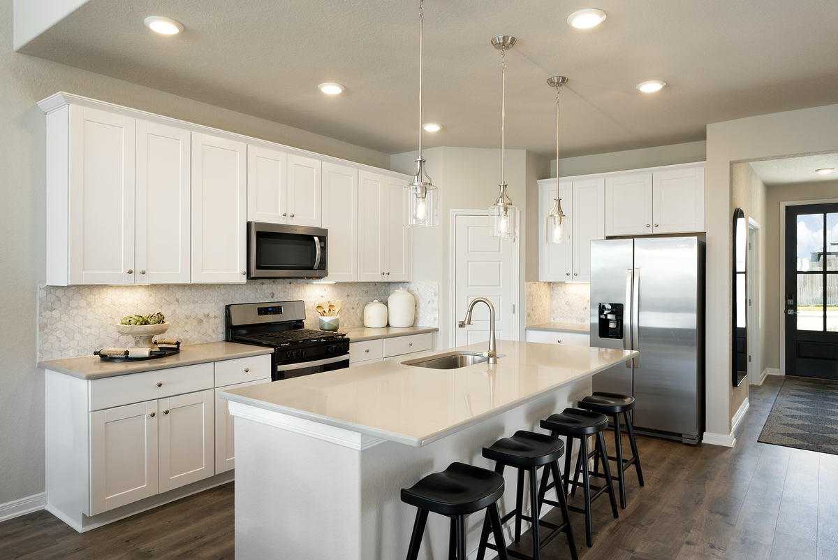 kitchen with white countertops & cabinets