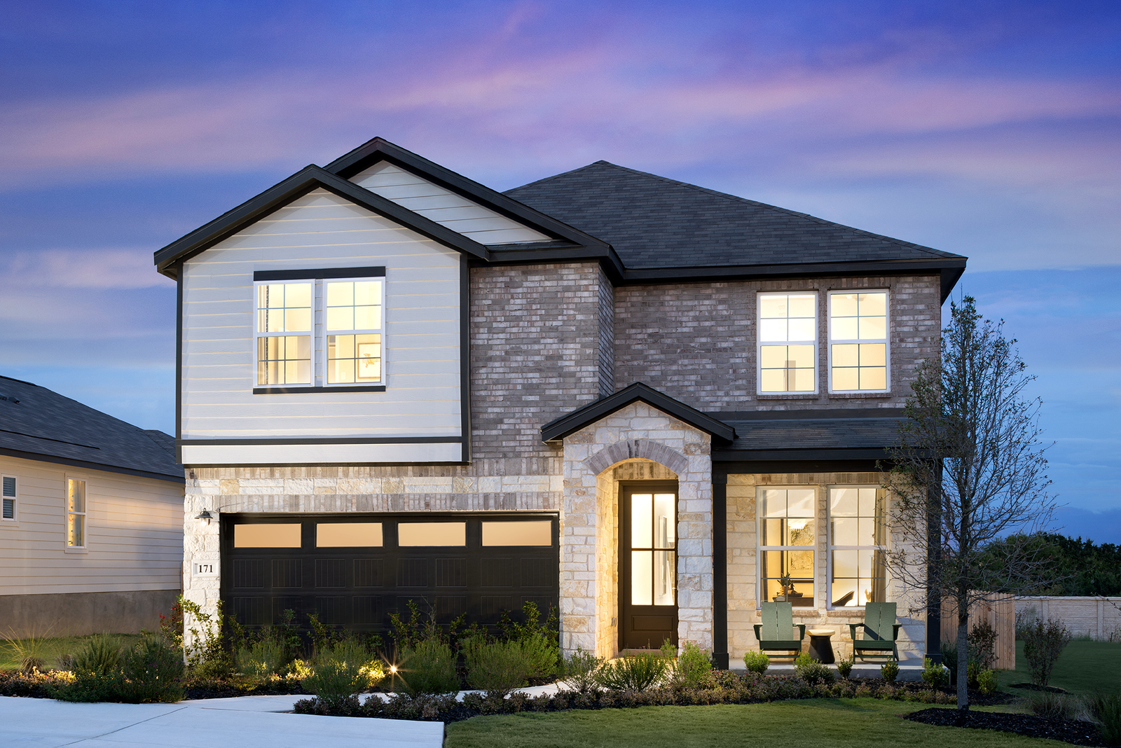 exterior with brick, stone & a covered porch 