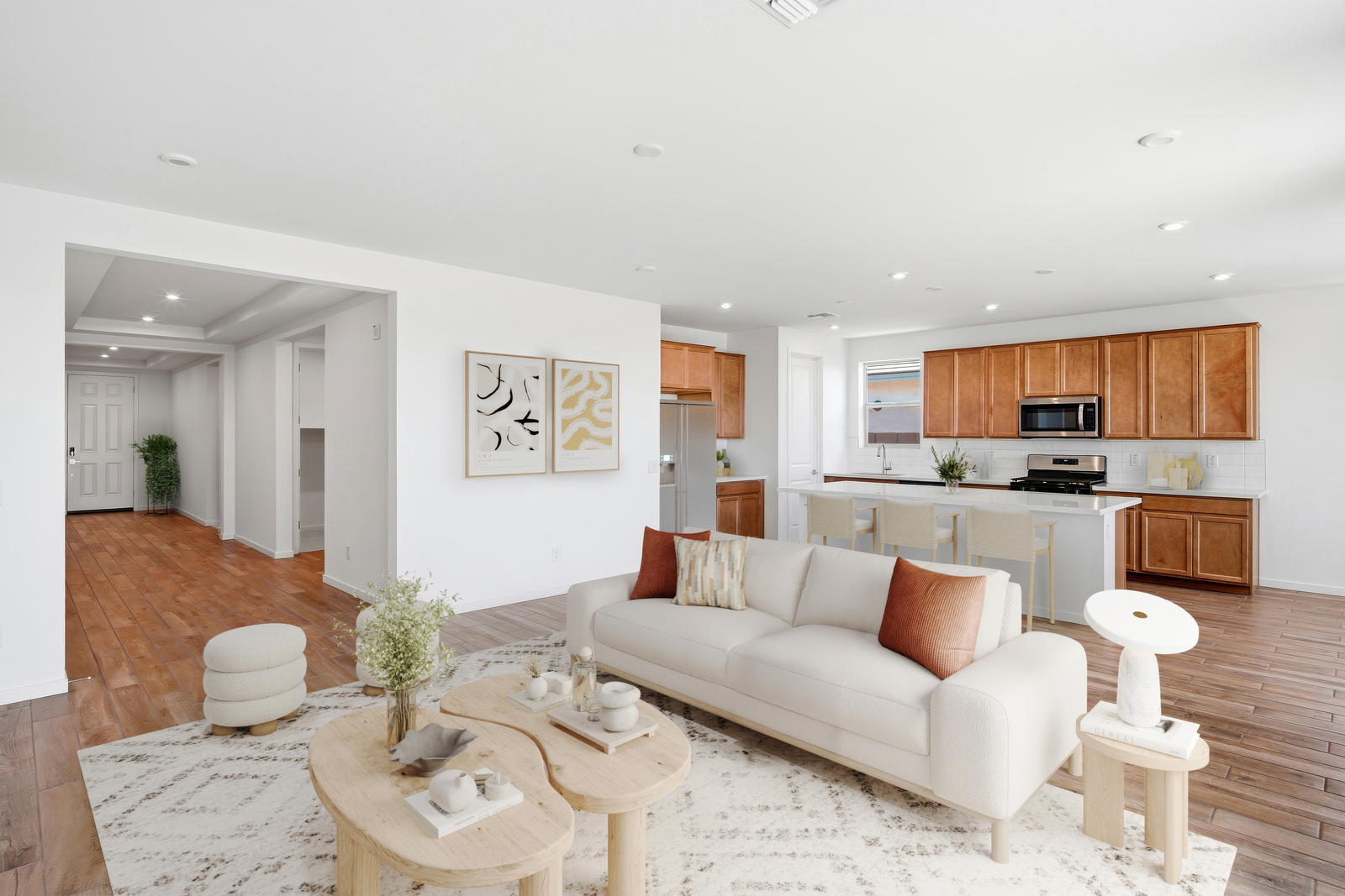 open-concept space with a large white rug, wooden coffee table, and large white couch