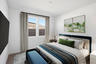 large bedroom with a large bed, a blue bench, a blue duvet cover, and a grey rug