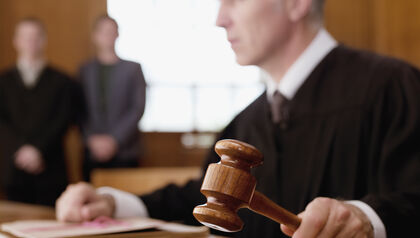 Judge holding a gavel in a courtroom