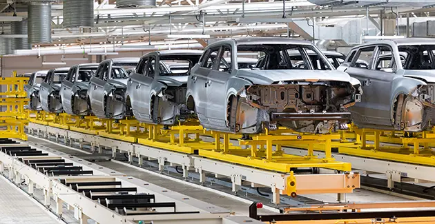 Row of unfinished car bodies on an automobile production line in a factory