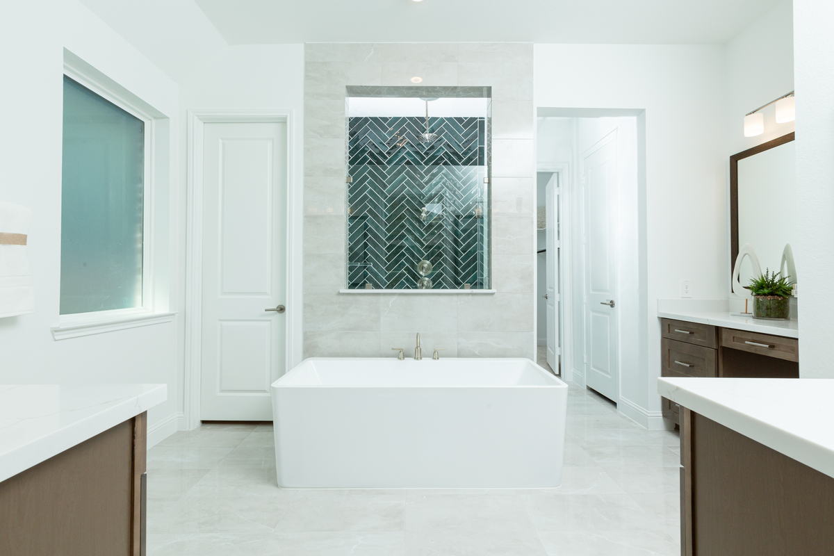 primary bathroom with tub, shower and vanity