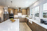 kitchen with wood-finish cabinets and white quartz counters