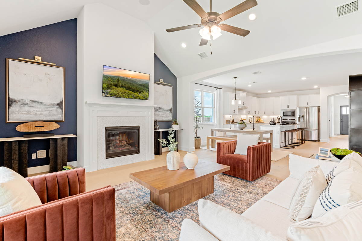 open great room with wood floors and fireplace