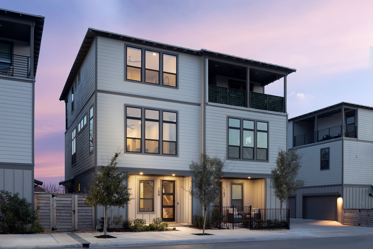 grey 3 story duet exterior with siding