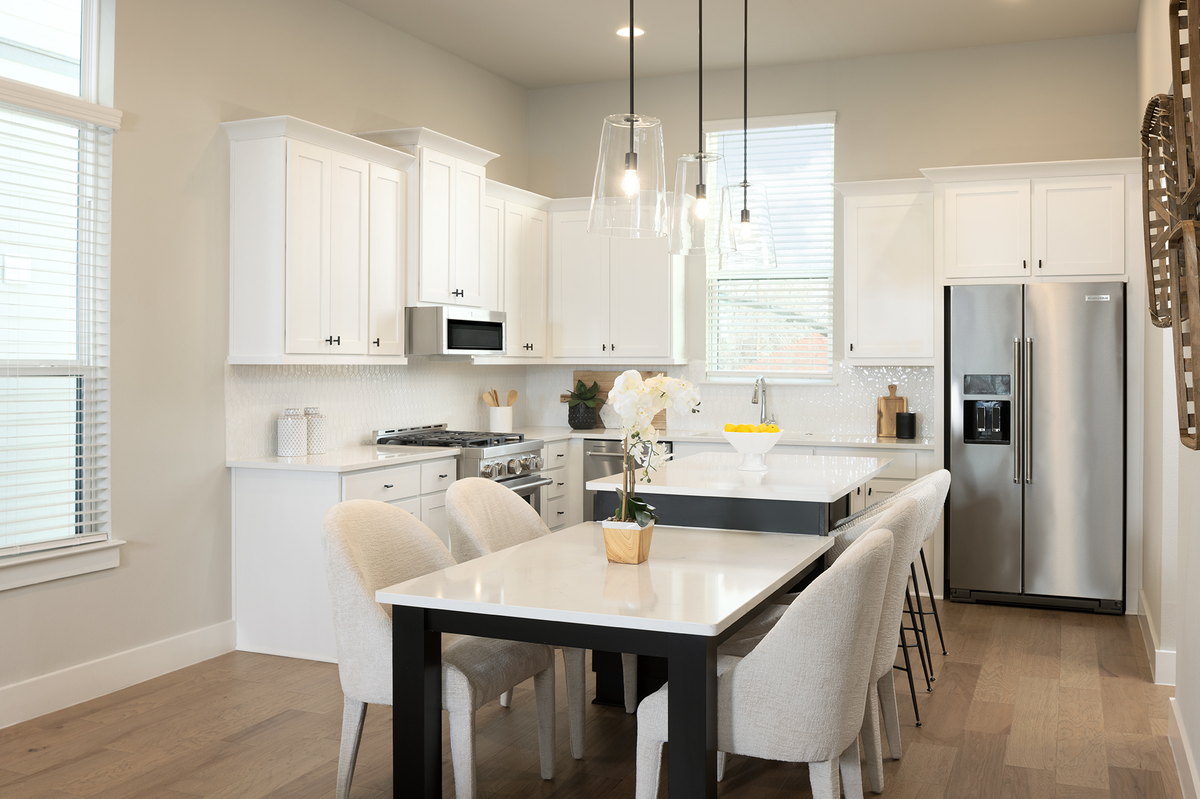 kitchen with white countertops & natural light