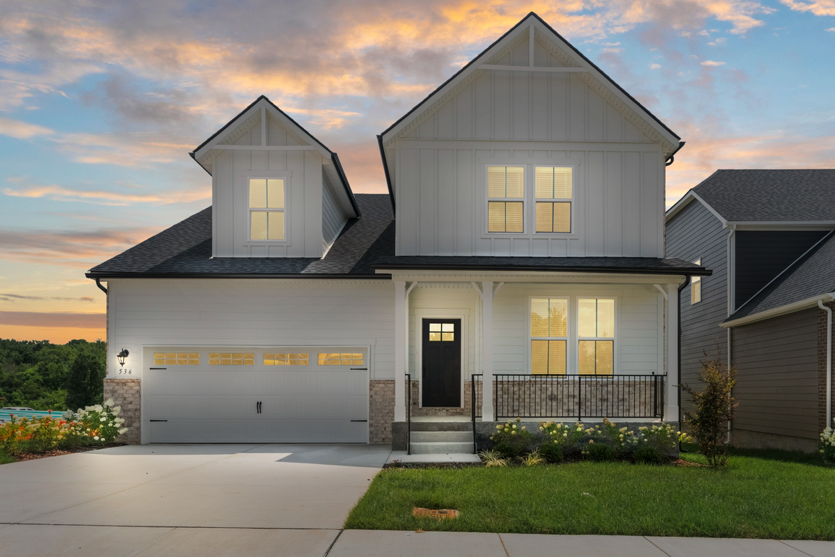 front exterior of home with brick entry and garage