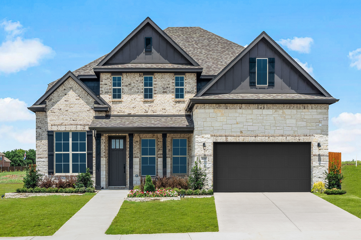 brick and stone exterior with grassy front yard