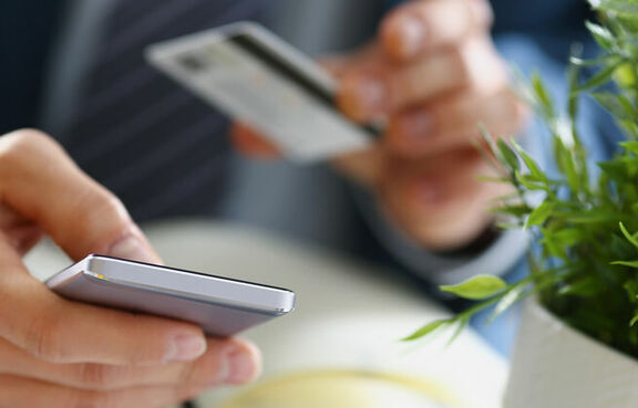 Man in suit paying with a credit card