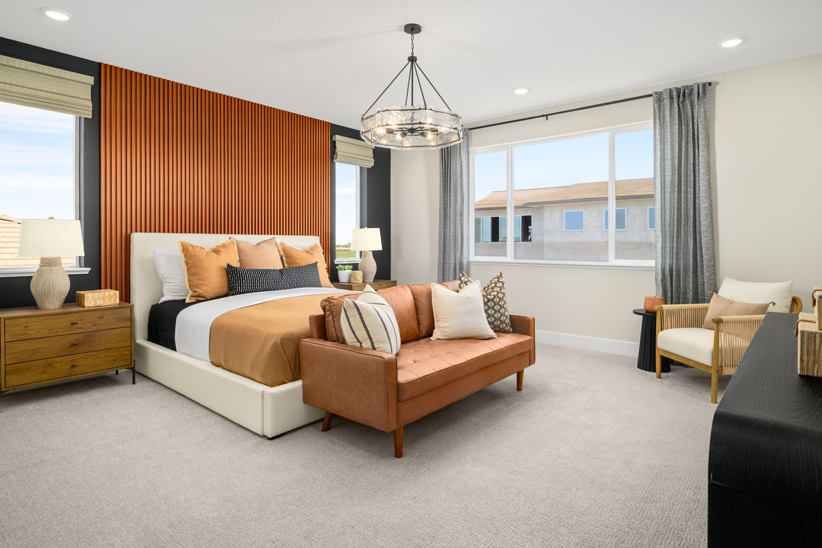 bedroom with wood accent wall and white bed