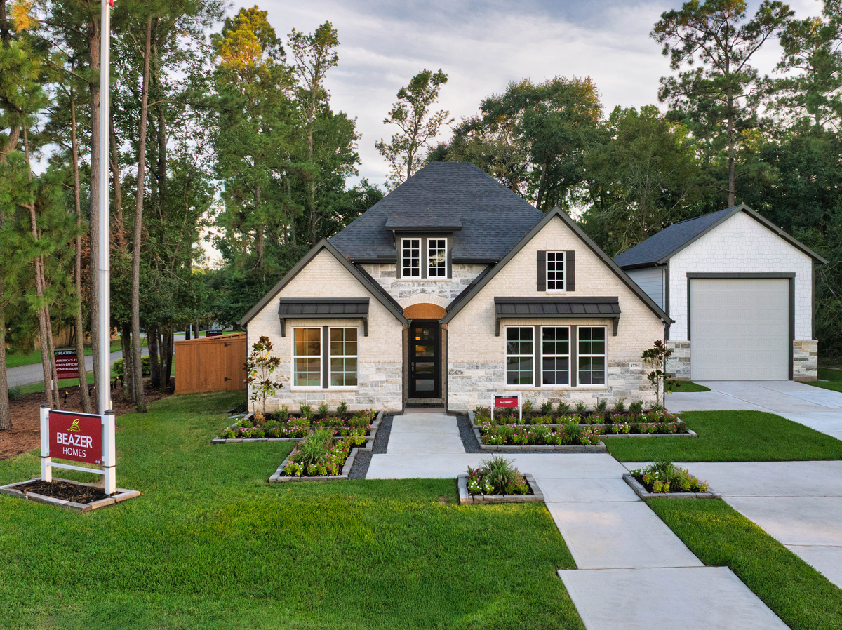 exterior brick and stone home with detached garage