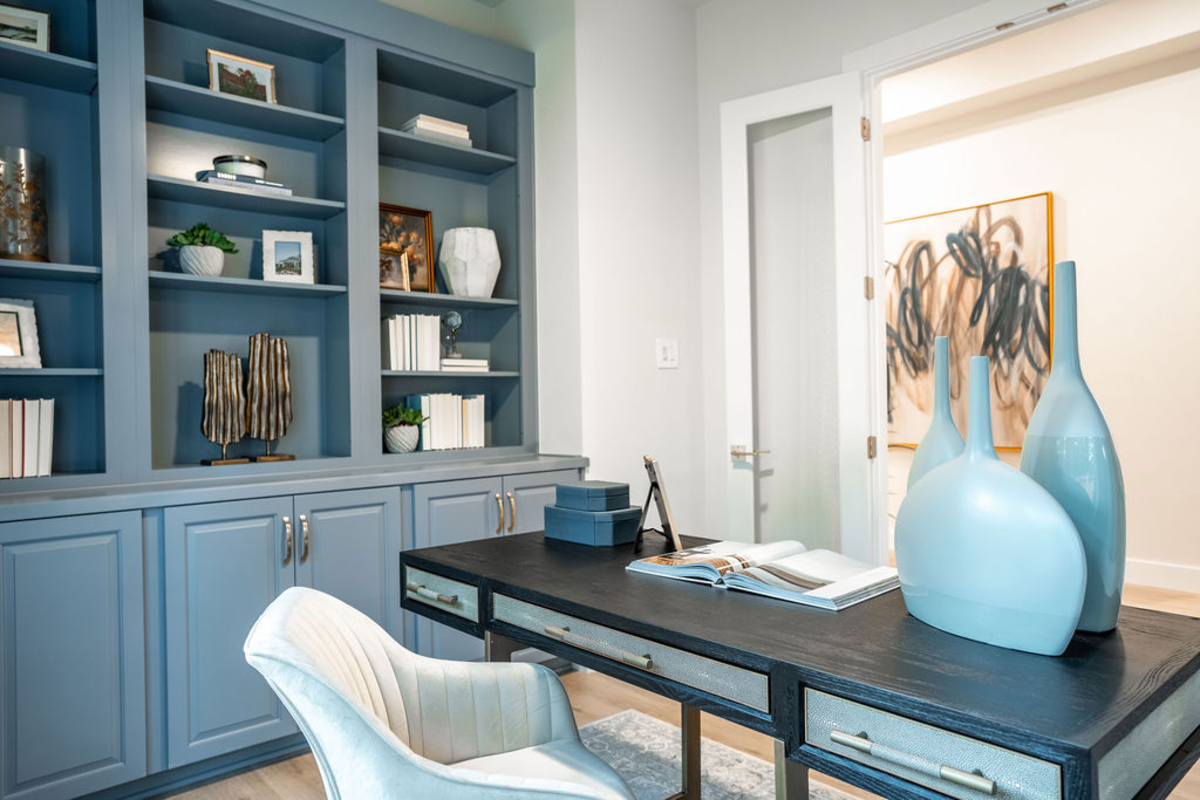 study with blue cabinet built-ins and desk