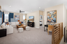 loft with neutral carpet and large windows