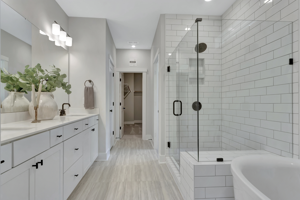 primary bathroom with shower and free standing tub