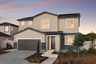 two-story exterior with a brown windowless garage and dark grey brick trim