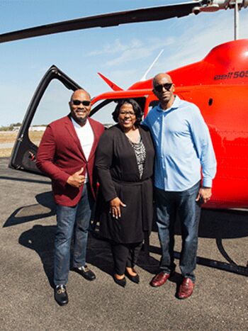 Victor Young shows his support for Moffitt with Valerie Goddard, chair of the George Edgecomb Society, and B. Lee Green, PhD, whose research focuses on cancer health disparities.