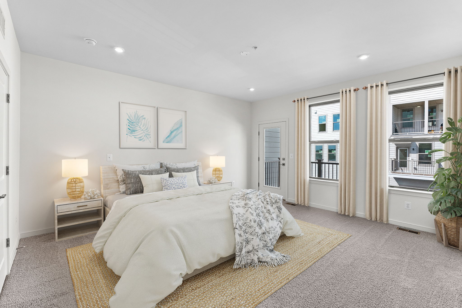 primary bedroom with two windows and bed