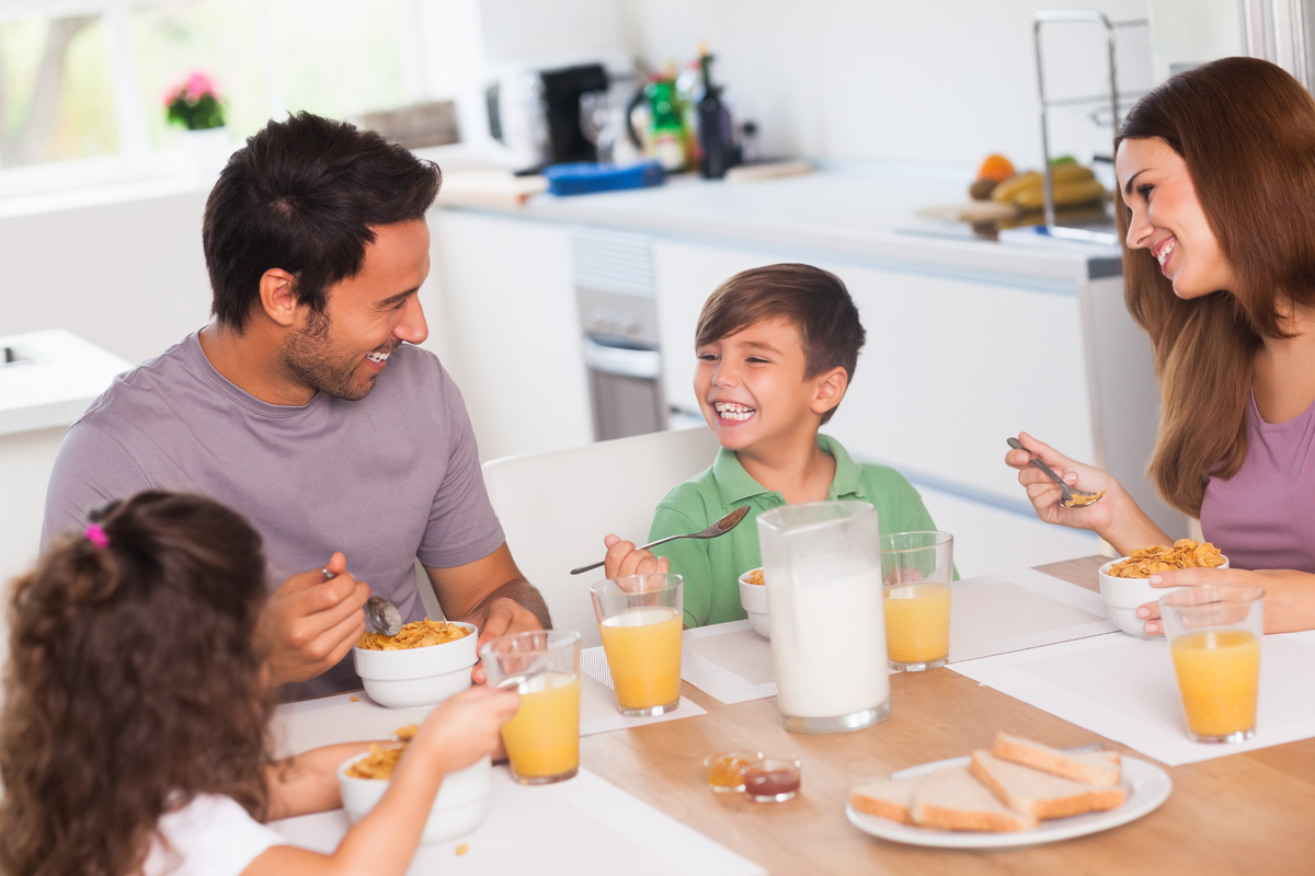family around a kitchen table eating
