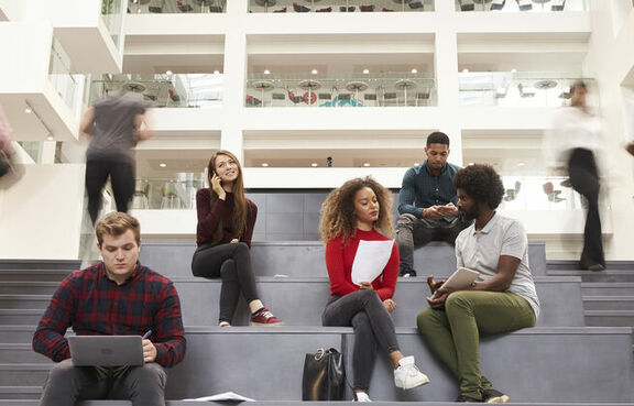 Nonprofit employees sitting on stairs of a lobby
