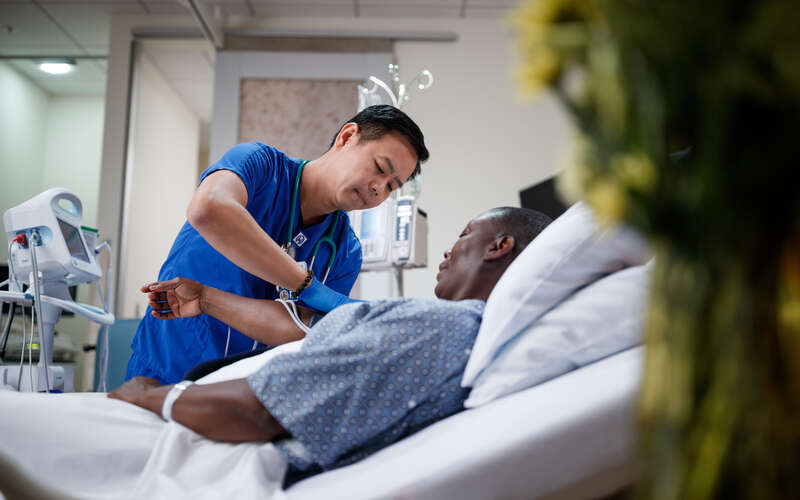 Nurse attends to patient in hospital
