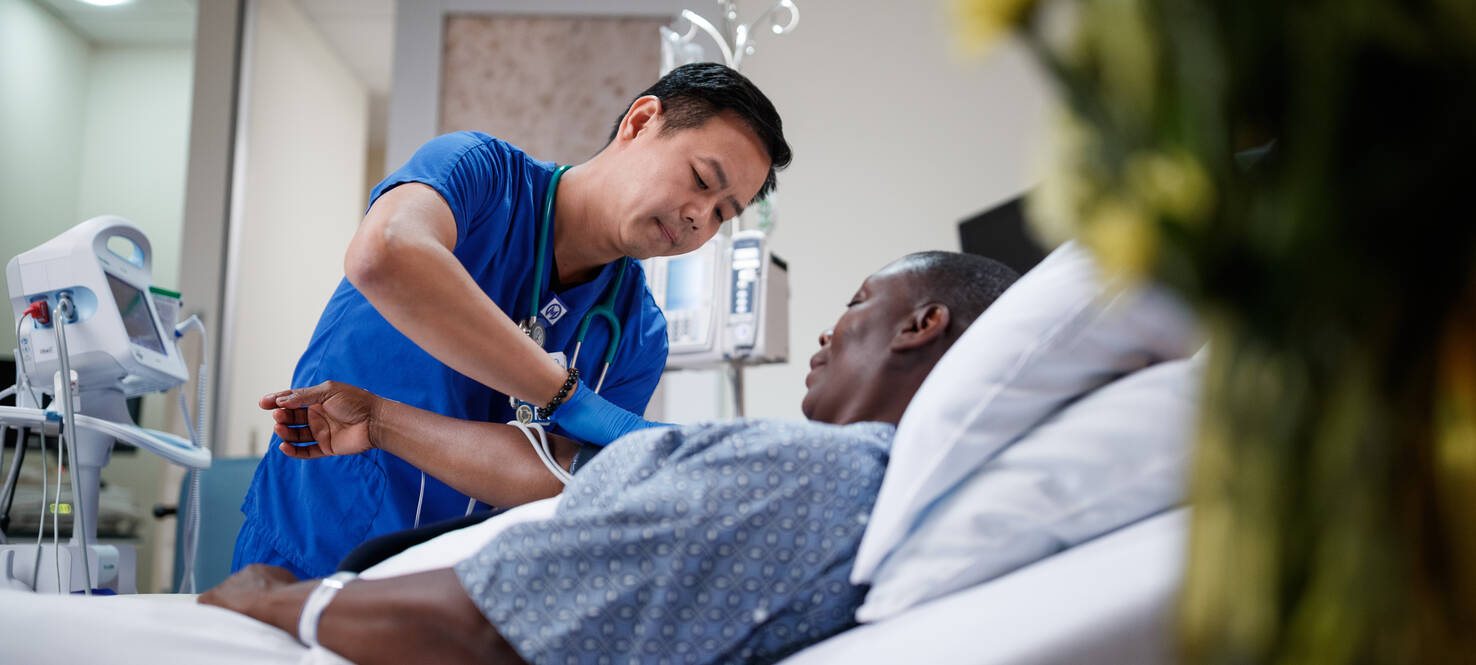 Nurse attends to patient in hospital