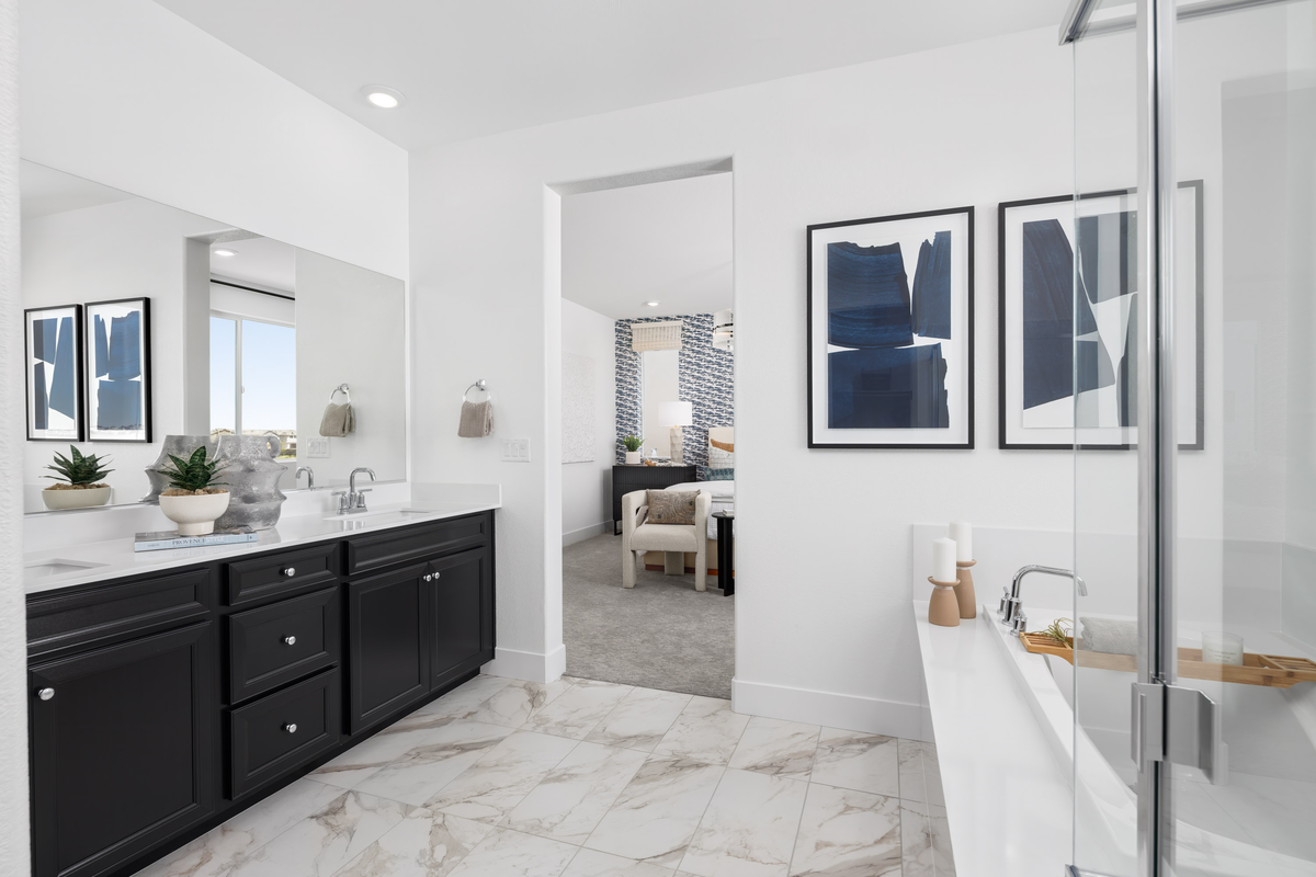 bathroom with black cabinets, and tub