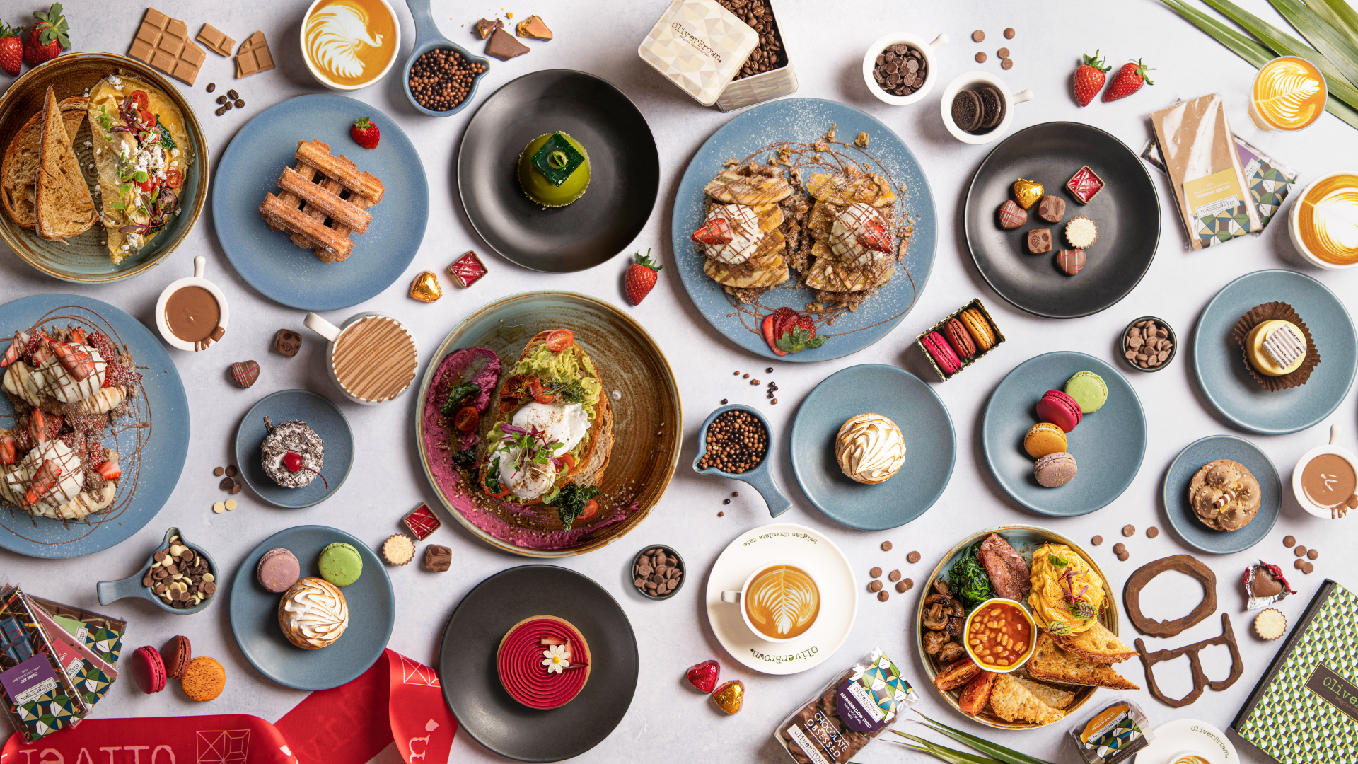 A table full of food from Oliver Brown, including coffee, meals and sweet treats.
