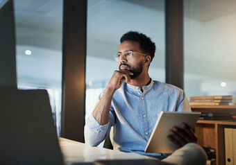 Man with blue shirt wearing occupational lenses while looking at screens