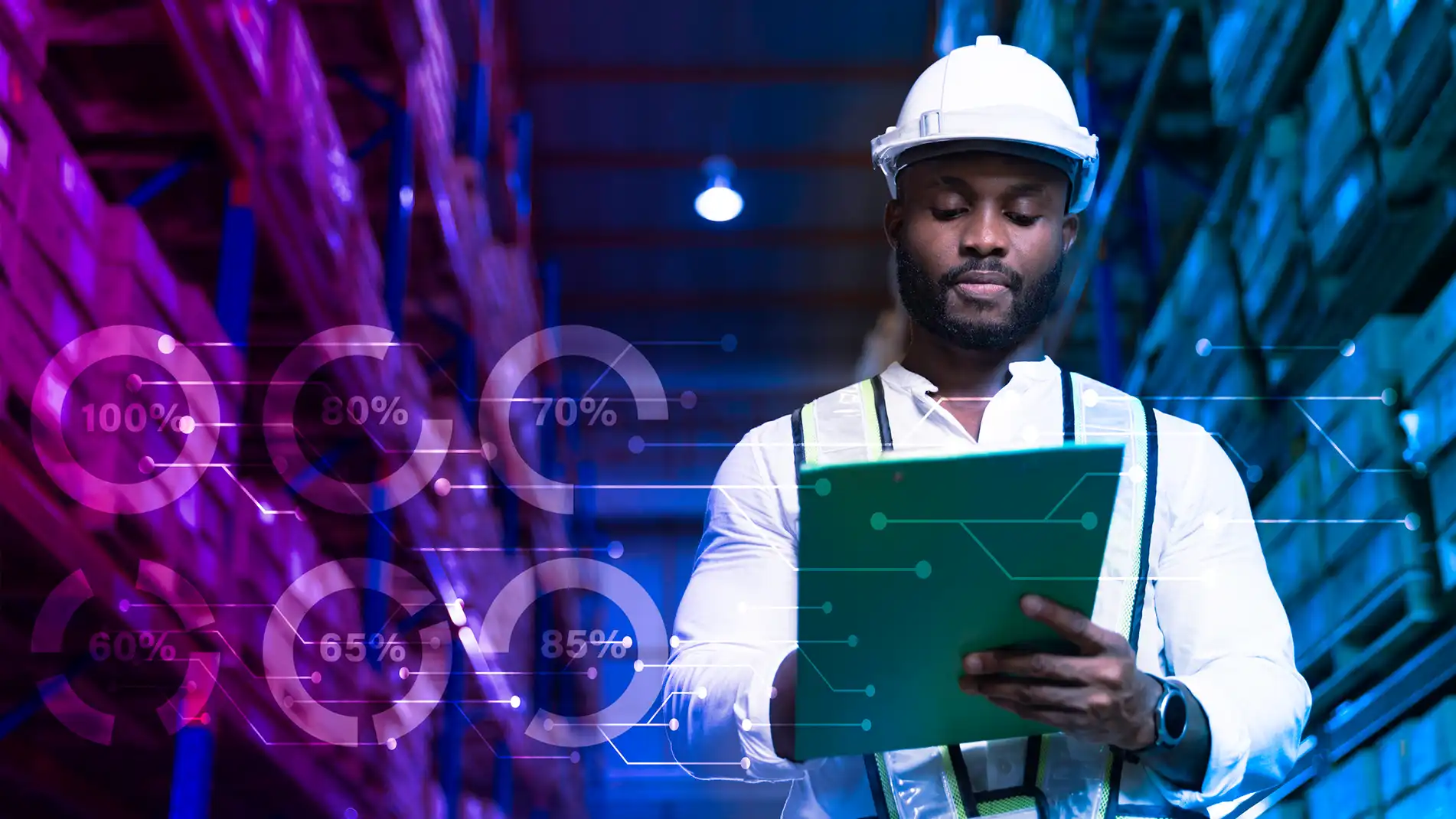 Optimized-Inventory-Performance-In-Page-1.webp Abstract image of a man wearing a hardhat and holding a tablet while standing in a warehouse.
