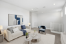 open-concept space with a large white couch, white coffee table, and blue accent chair